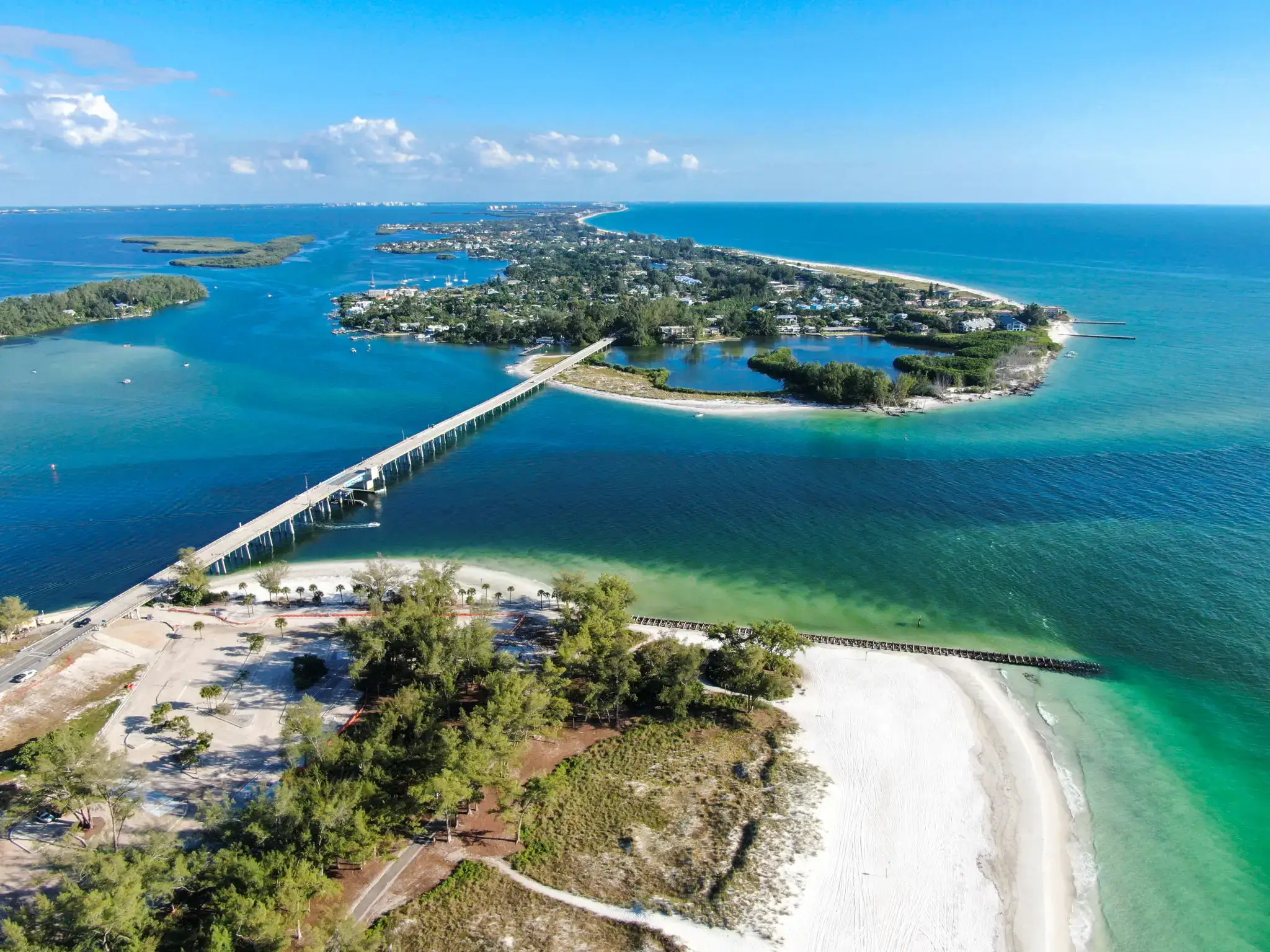 Aerial view of a coastal area with a bridge connecting islands.