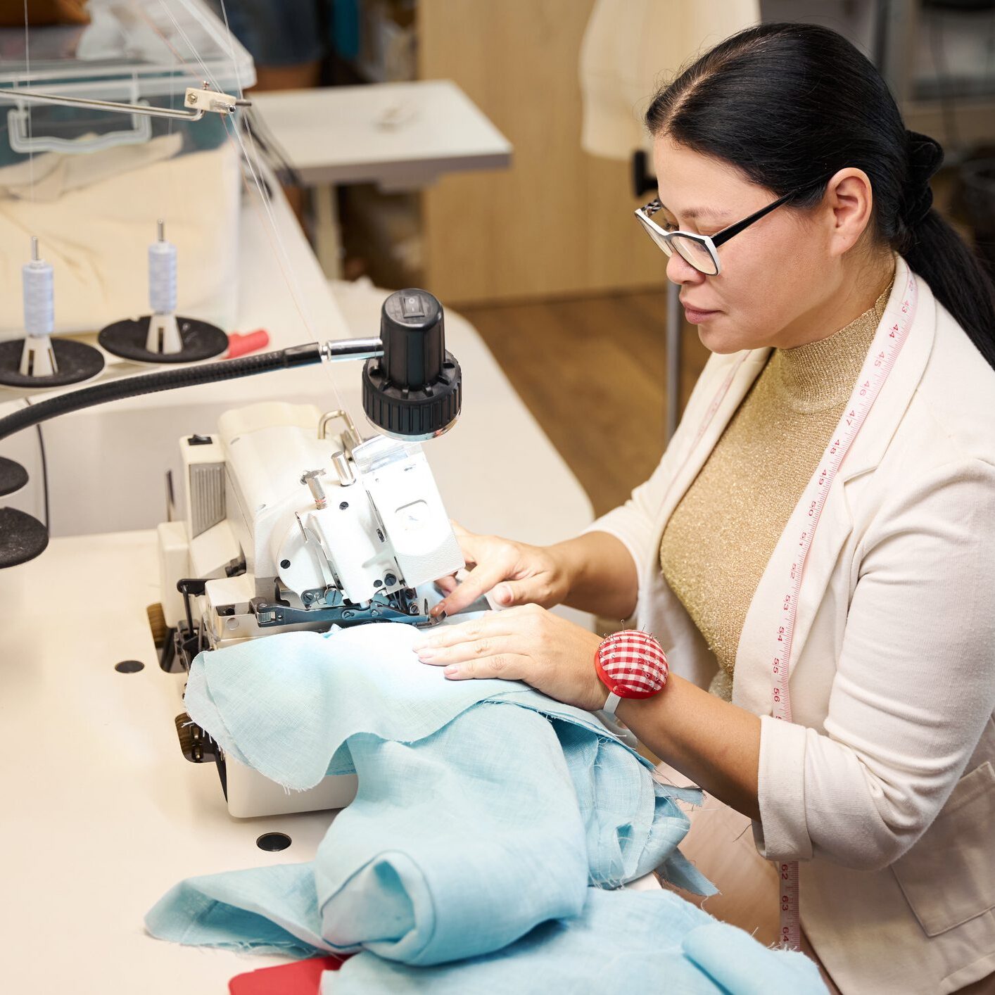 Scientist examining a baby monkey under a microscope in a lab.